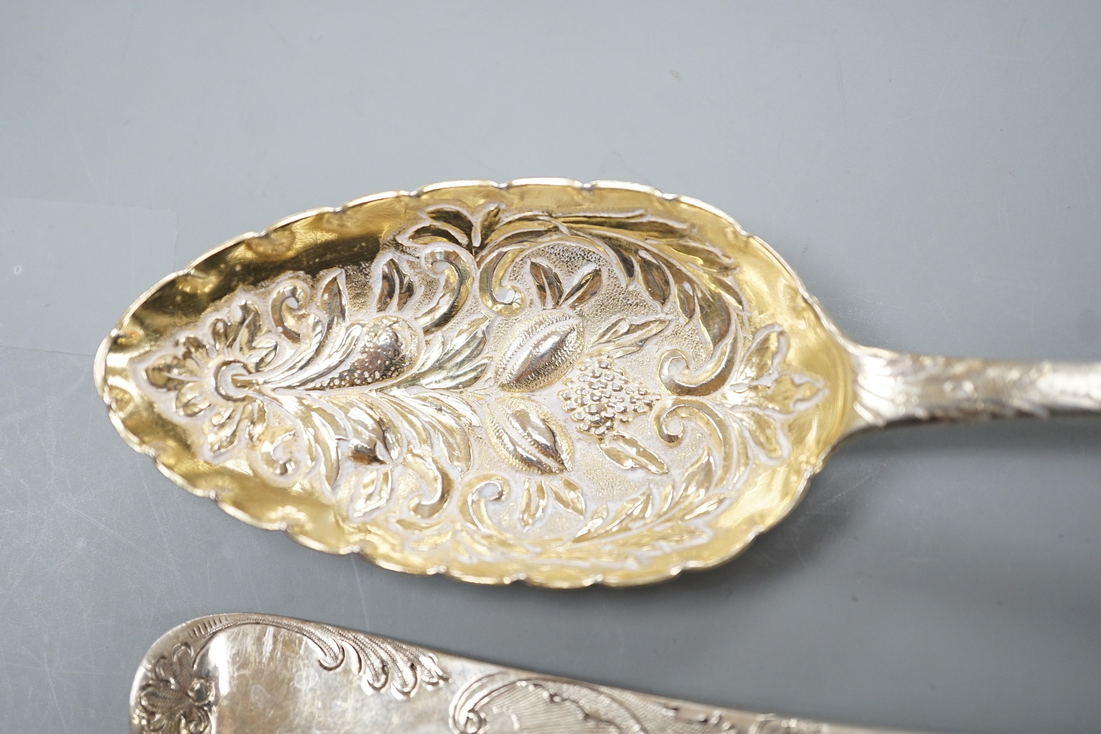 Two George III silver 'berry spoons', a pair of Victorian silver apostle serving spoons, Josiah Williams & Co, London, 1888, 19.8cm and a continental white metal spoon.